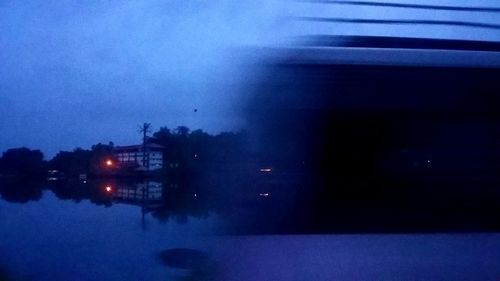 Illuminated building against sky at dusk