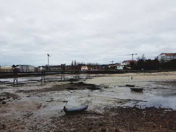 Boats moored on shore against sky