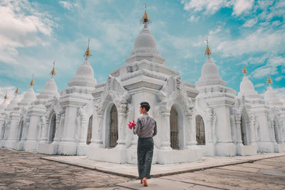 Full length of man standing outside temple against building