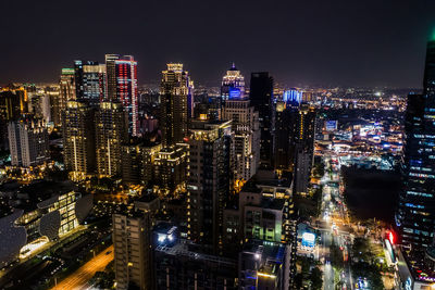 High angle view of illuminated city buildings at night