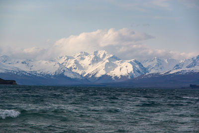 Scenic view of sea and mountains against sky