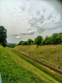 Scenic view of grassy field against sky