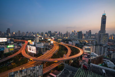 High angle view of city lit up at night