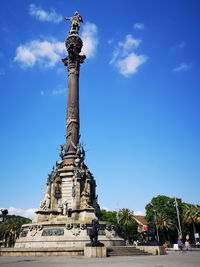 Low angle view of statue against blue sky