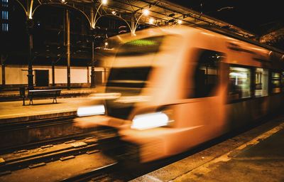 Blurred motion of train at railroad station at night