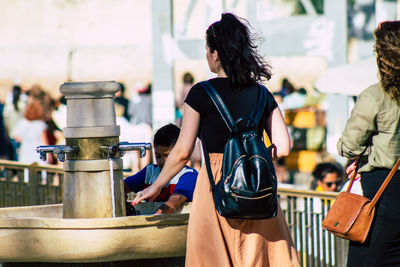 Rear view of people standing outdoors