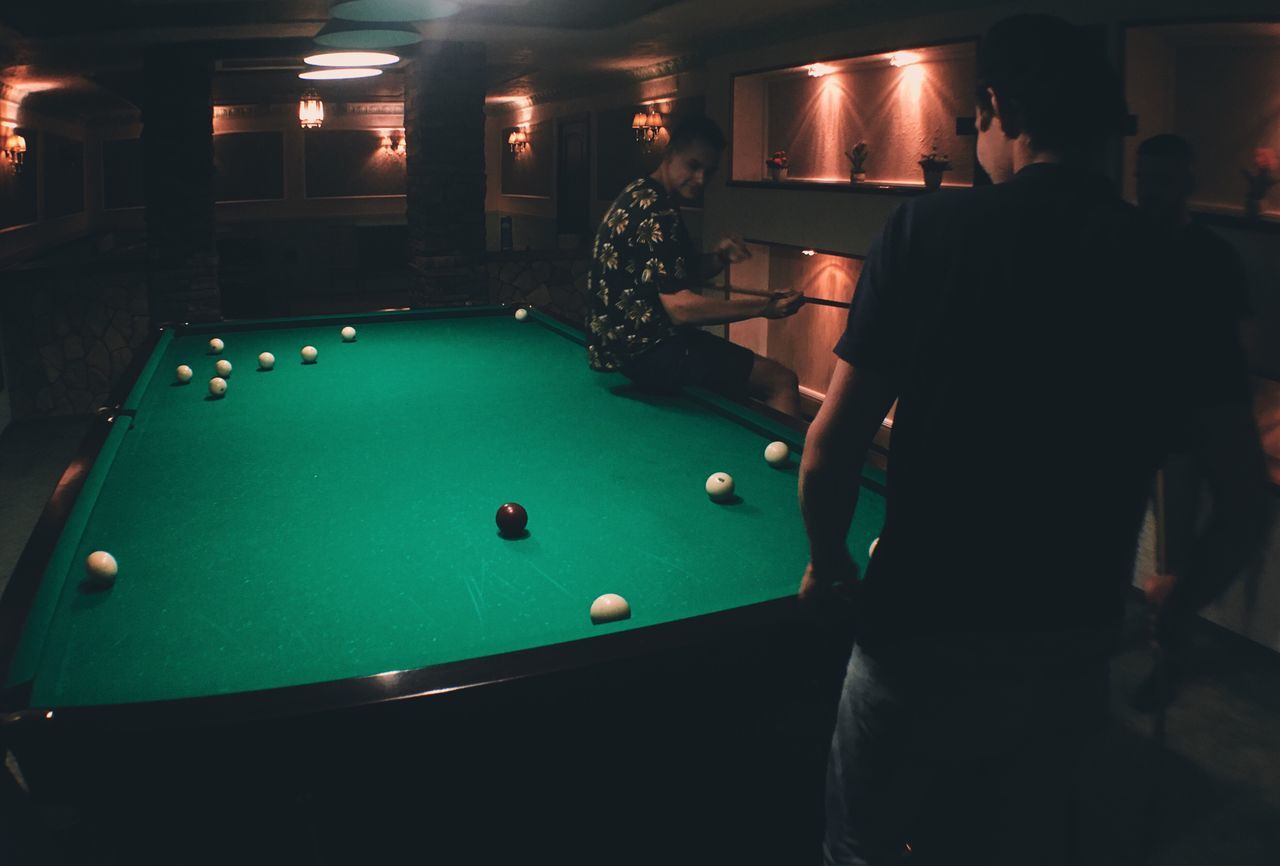 pool table, pool ball, pool - cue sport, pool cue, snooker, leisure activity, indoors, leisure games, sport, playing, pool hall, snooker and pool, ball, arts culture and entertainment, one person, lifestyles, cue ball, real people, snooker ball, men, illuminated, competition, night, adult, people