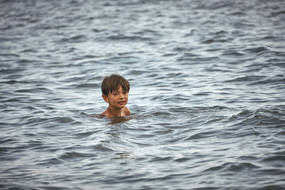 Portrait of boy swimming in sea