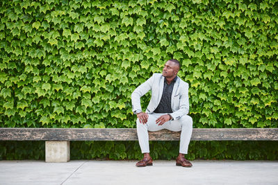 African american man sitting on a park bench