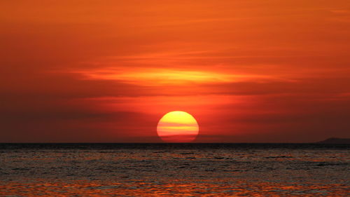 Scenic view of sea against orange sky