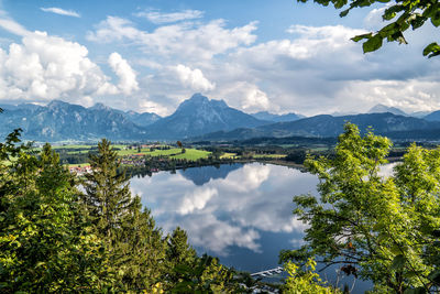 Scenic view of trees and mountains against sky