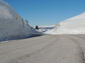 Scenic view of snowcapped mountains against clear blue sky