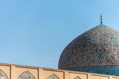 Low angle view of mosque against blue sky