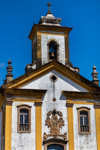 Low angle view of building against clear blue sky