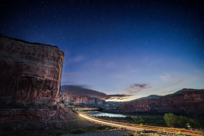 Scenic view of illuminated mountains against sky at night