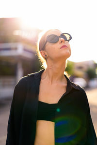 Young woman wearing sunglasses standing outdoors