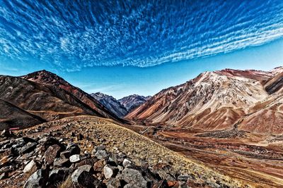 Scenic view of snowcapped mountains against blue sky