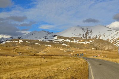 Scenic view of snow covered mountains against clear sky