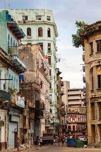 Street amidst buildings in city against sky