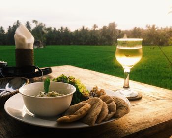 High angle view of food with white wine on table at lawn