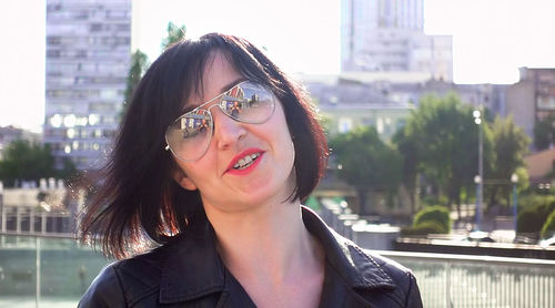 Portrait of smiling young woman in city