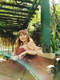 Portrait of woman sitting outdoors