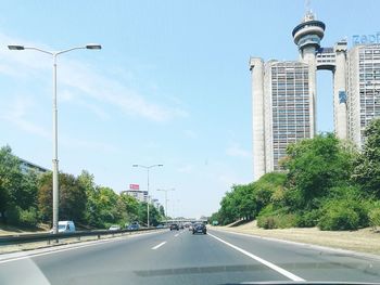 Road in city against sky