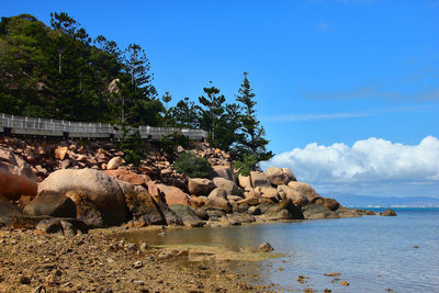 Rocks by sea against sky