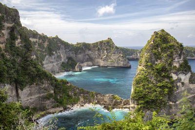 Scenic view of cliff and sea against sky