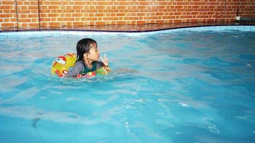 Full length of boy swimming in pool