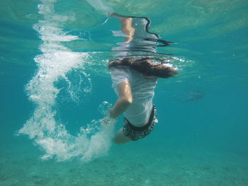 Woman swimming undersea