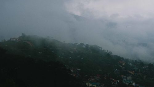 Scenic view of mountains against cloudy sky