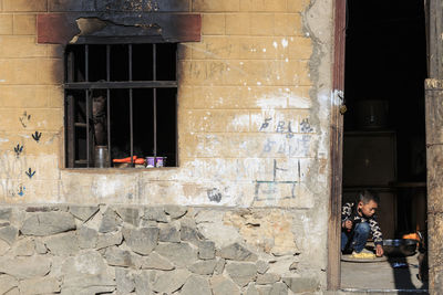 Man on window of building