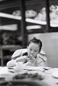 Girl having food in restaurant