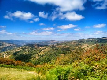 Scenic view of mountains against blue sky