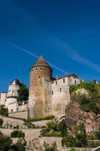 Low angle view of old ruins against blue sky