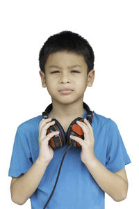 Portrait of boy standing against white background