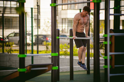 Muscular man exercising at park