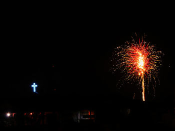 Low angle view of firework display at night