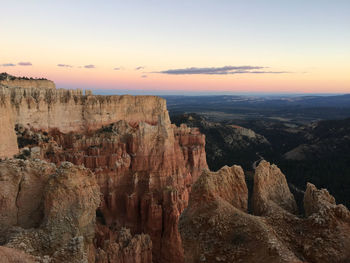 Scenic view of rocky mountains against sky during sunset