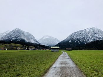 Scenic view of landscape and mountains against clear sky