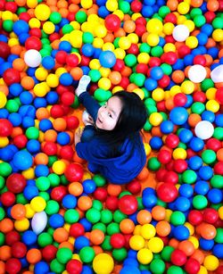 High angle portrait of girl playing in ball pool