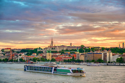 View of buildings against cloudy sky during sunset