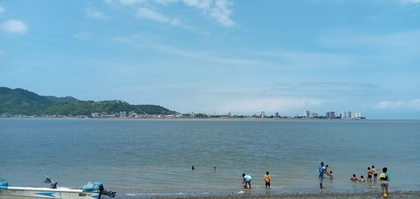 People on beach against sky