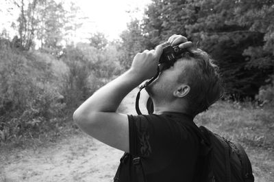 Rear view of a man looking at trees