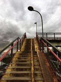 View of footbridge against cloudy sky