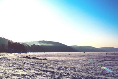 Scenic view of field against clear sky during winter