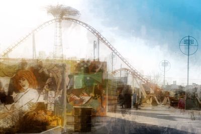 Man in amusement park against sky