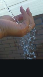 Close-up of cropped hand in water