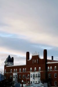 Low angle view of buildings against sky during sunset